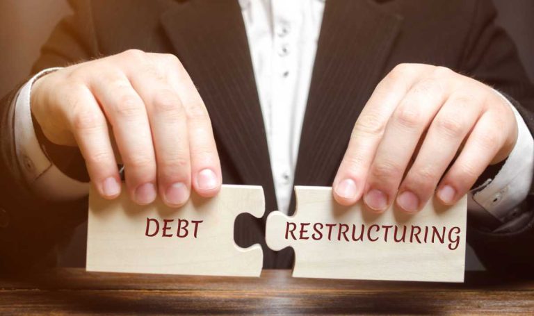 Two puzzle pieces saying debt restructuring