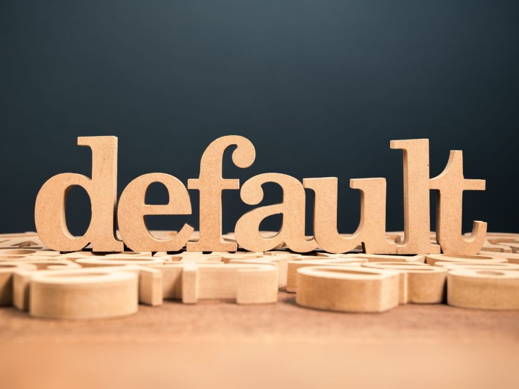 wooden blocks spelling out default in this article that asks 